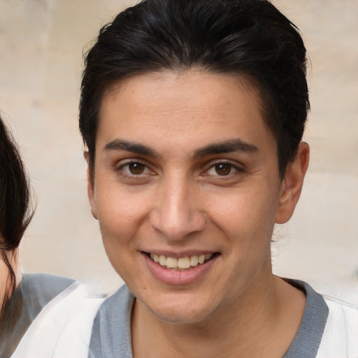 Joyful white young-adult male with medium  brown hair and brown eyes