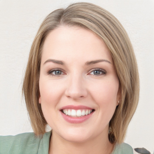 Joyful white young-adult female with long  brown hair and blue eyes