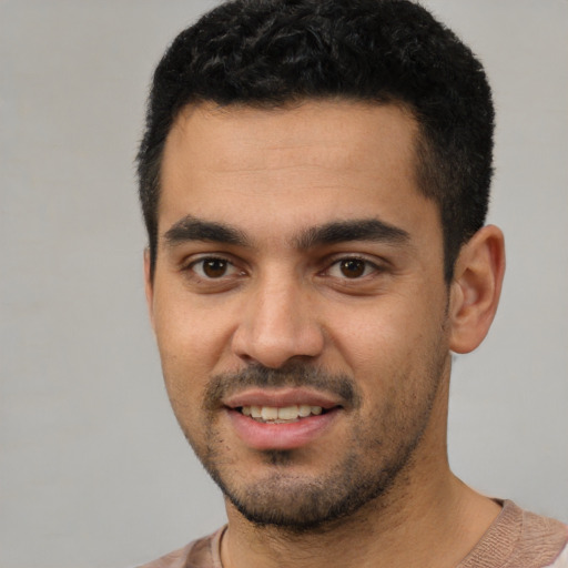 Joyful white young-adult male with short  black hair and brown eyes