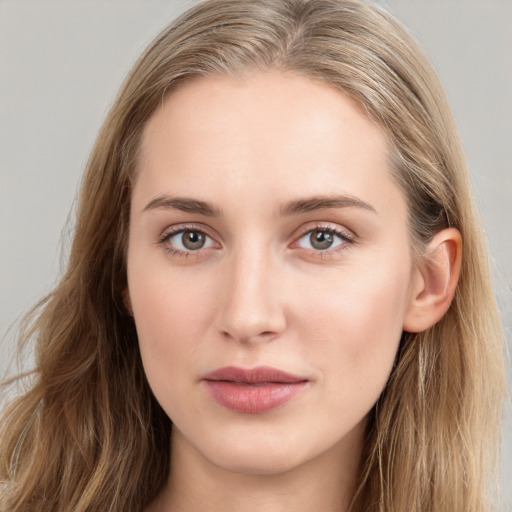 Joyful white young-adult female with long  brown hair and blue eyes