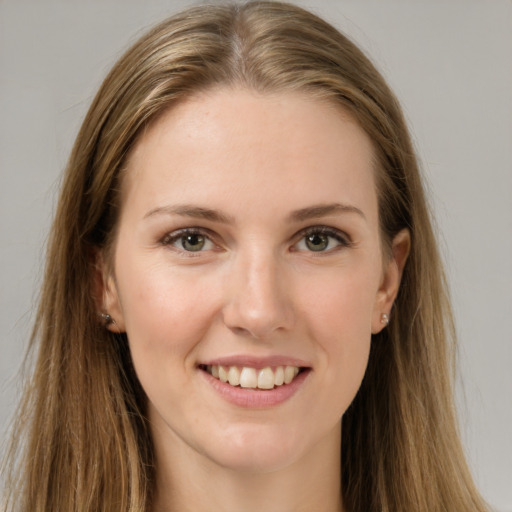 Joyful white young-adult female with long  brown hair and grey eyes