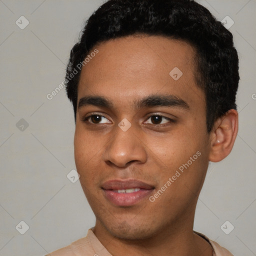 Joyful black young-adult male with short  black hair and brown eyes