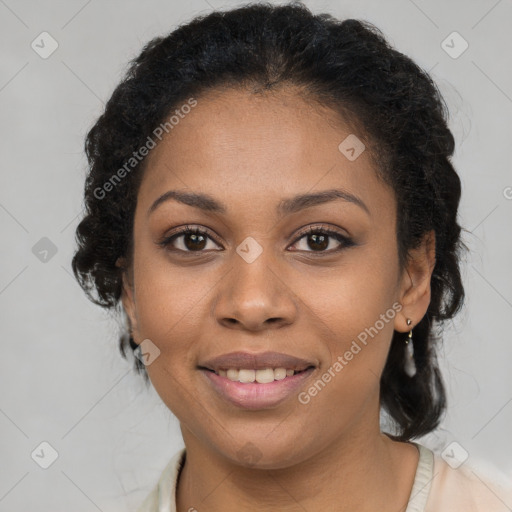 Joyful black young-adult female with long  brown hair and brown eyes