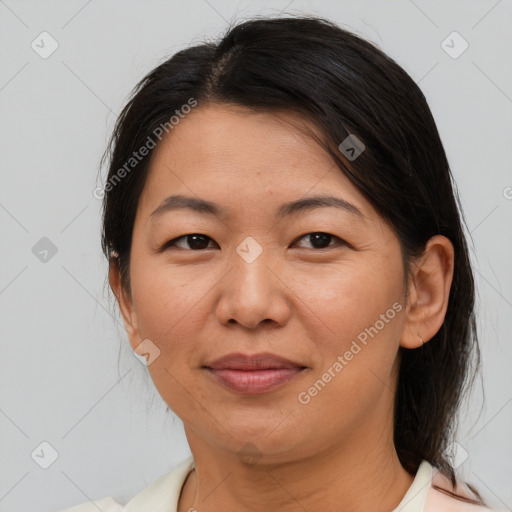 Joyful latino adult female with medium  brown hair and brown eyes