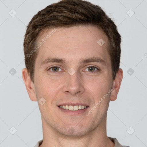 Joyful white young-adult male with short  brown hair and grey eyes