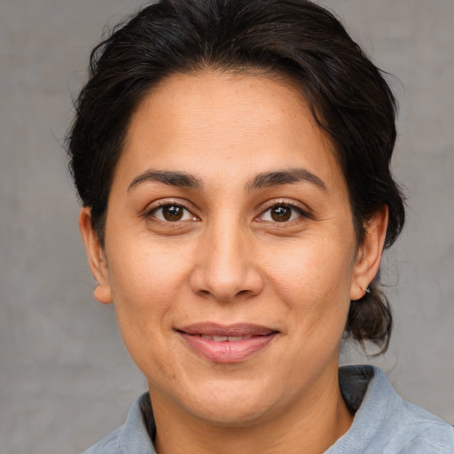 Joyful white adult female with short  brown hair and brown eyes