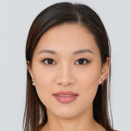 Joyful asian young-adult female with long  brown hair and brown eyes