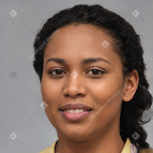 Joyful black young-adult female with long  black hair and brown eyes