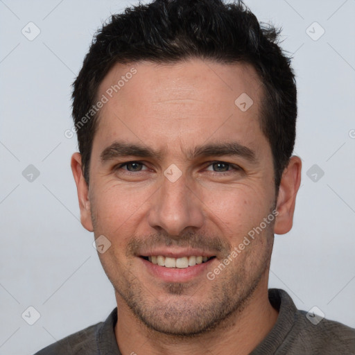 Joyful white adult male with short  brown hair and brown eyes