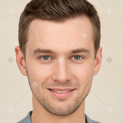 Joyful white young-adult male with short  brown hair and grey eyes