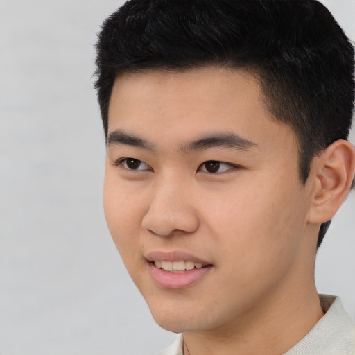 Joyful asian young-adult male with short  black hair and brown eyes