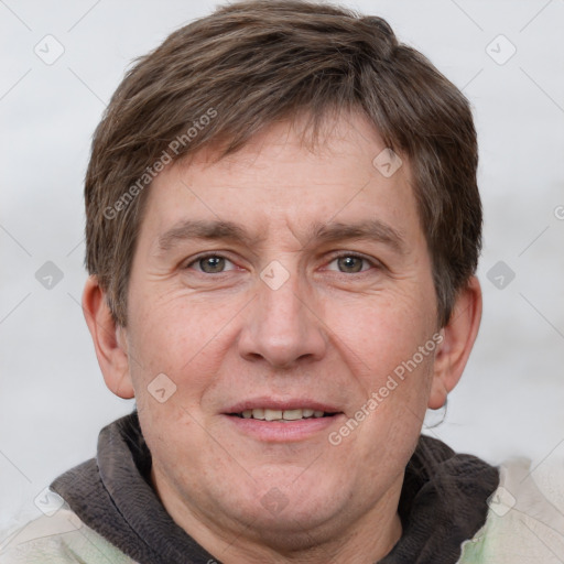 Joyful white adult male with short  brown hair and grey eyes