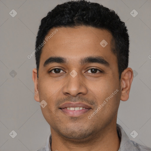 Joyful latino young-adult male with short  black hair and brown eyes