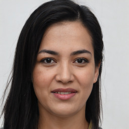 Joyful latino young-adult female with long  brown hair and brown eyes