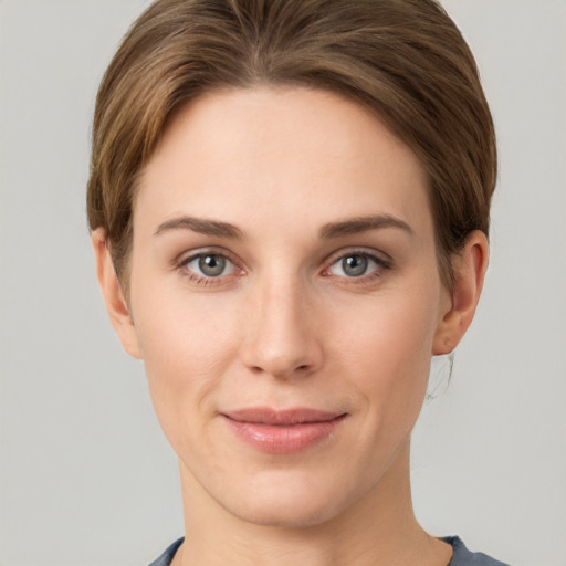 Joyful white young-adult female with short  brown hair and grey eyes