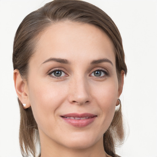 Joyful white young-adult female with medium  brown hair and grey eyes