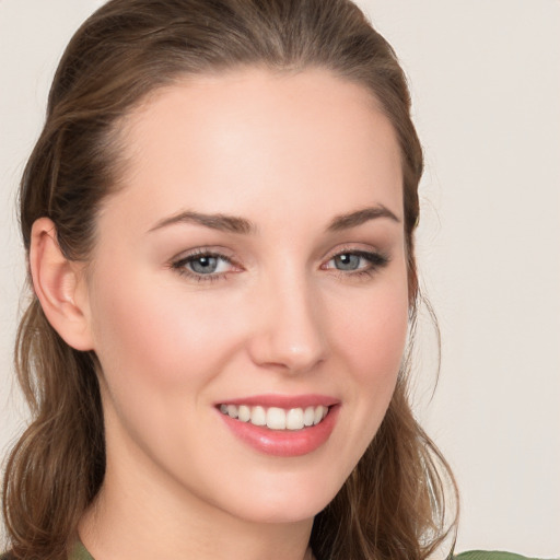 Joyful white young-adult female with long  brown hair and grey eyes