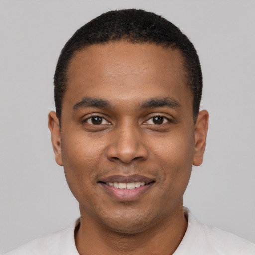Joyful black young-adult male with short  black hair and brown eyes