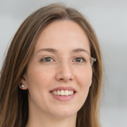 Joyful white young-adult female with long  brown hair and grey eyes