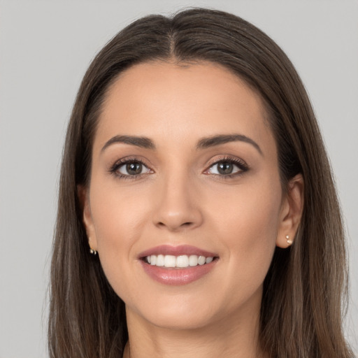 Joyful white young-adult female with long  brown hair and brown eyes