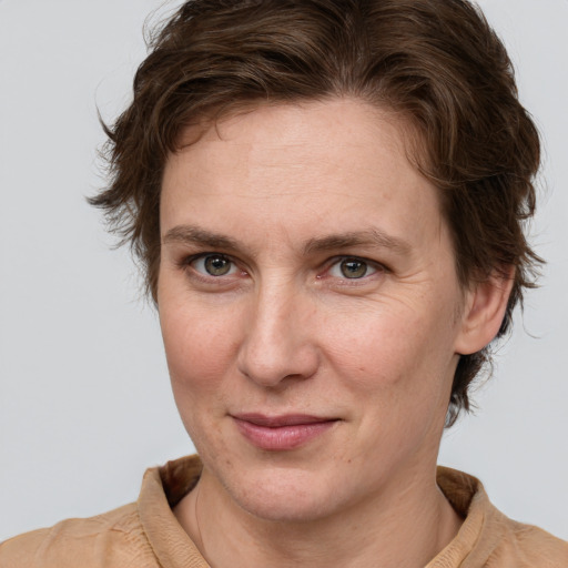 Joyful white adult female with short  brown hair and grey eyes