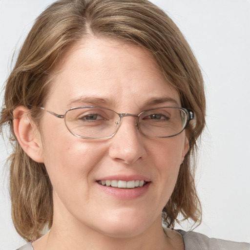 Joyful white adult female with medium  brown hair and blue eyes