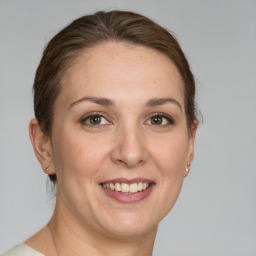 Joyful white adult female with short  brown hair and grey eyes