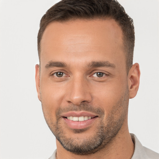 Joyful white young-adult male with short  brown hair and brown eyes