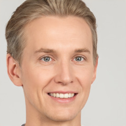 Joyful white adult male with short  brown hair and grey eyes