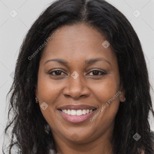 Joyful black young-adult female with long  brown hair and brown eyes