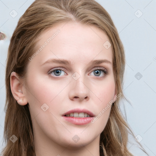 Joyful white young-adult female with long  brown hair and blue eyes