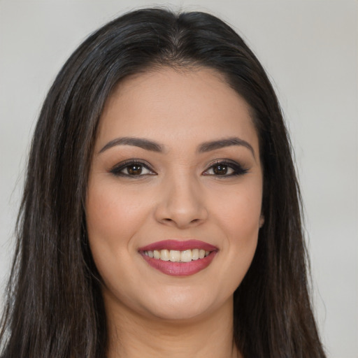 Joyful white young-adult female with long  brown hair and brown eyes