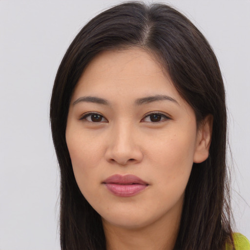 Joyful asian young-adult female with long  brown hair and brown eyes