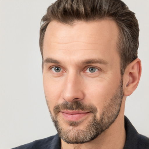 Joyful white adult male with short  brown hair and brown eyes