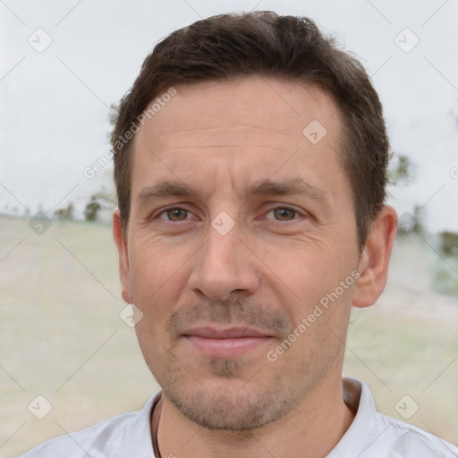 Joyful white adult male with short  brown hair and brown eyes