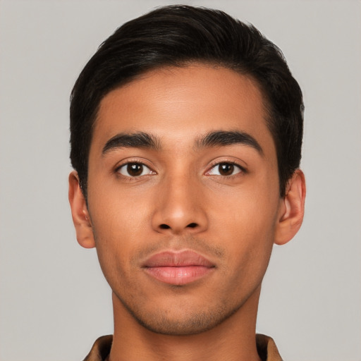 Joyful latino young-adult male with short  brown hair and brown eyes