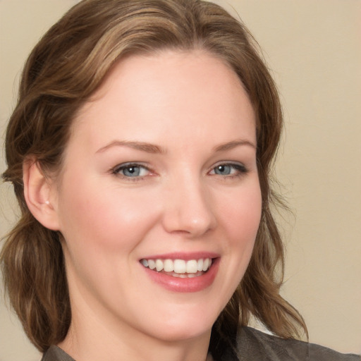 Joyful white young-adult female with medium  brown hair and blue eyes