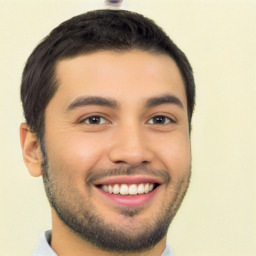 Joyful latino young-adult male with short  black hair and brown eyes