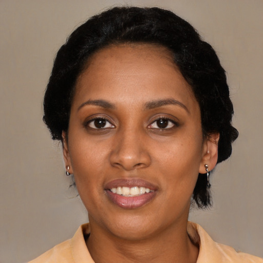 Joyful black adult female with medium  black hair and brown eyes