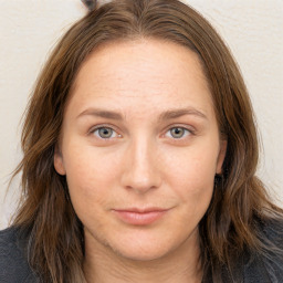 Joyful white adult female with long  brown hair and brown eyes