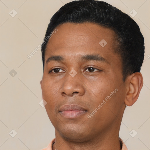 Joyful black young-adult male with short  black hair and brown eyes