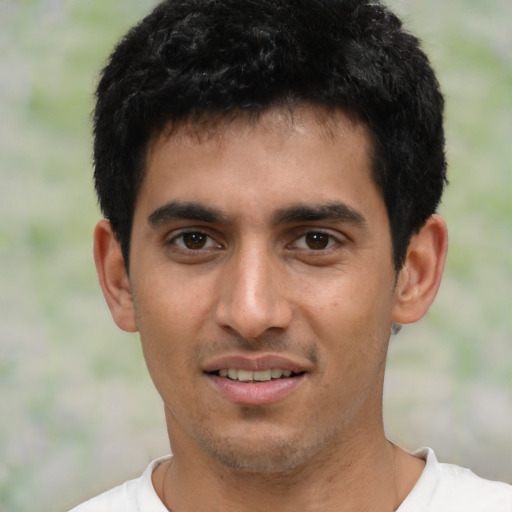 Joyful latino young-adult male with short  black hair and brown eyes