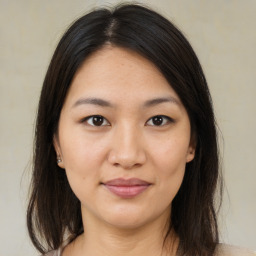 Joyful asian young-adult female with medium  brown hair and brown eyes