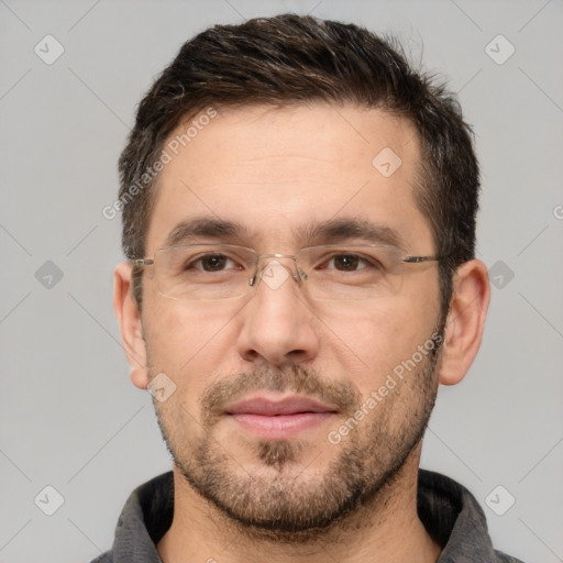 Joyful white adult male with short  brown hair and brown eyes