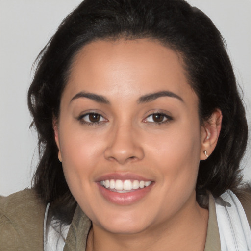 Joyful latino young-adult female with medium  brown hair and brown eyes