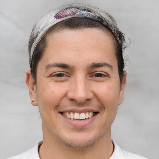 Joyful white adult male with short  brown hair and brown eyes