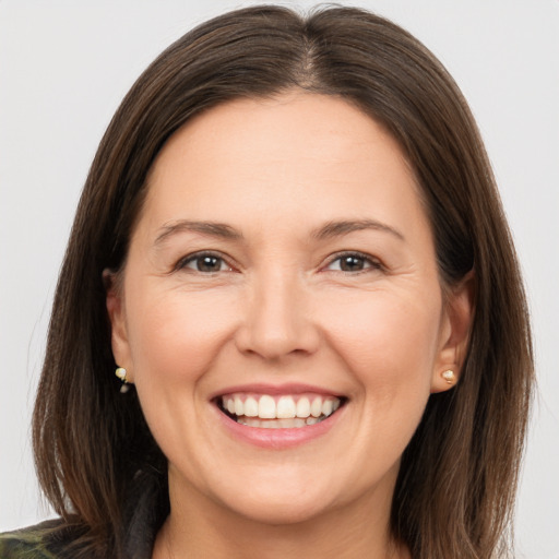 Joyful white adult female with medium  brown hair and brown eyes