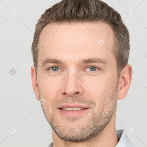 Joyful white young-adult male with short  brown hair and grey eyes