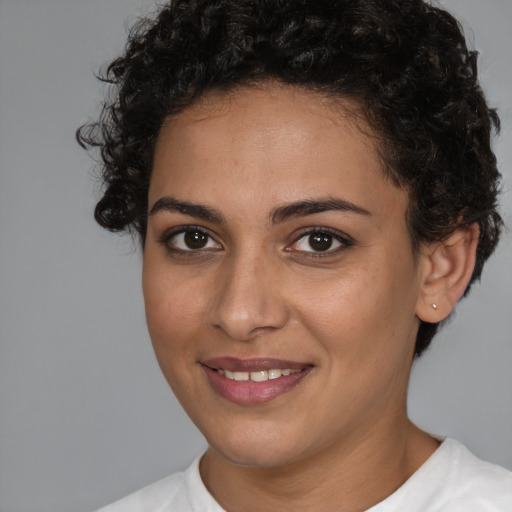 Joyful white young-adult female with short  brown hair and brown eyes