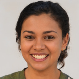 Joyful latino young-adult female with medium  brown hair and brown eyes